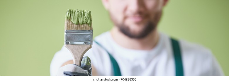 Close Up Of Professional Man Holding Green Paint Brush, Panorama