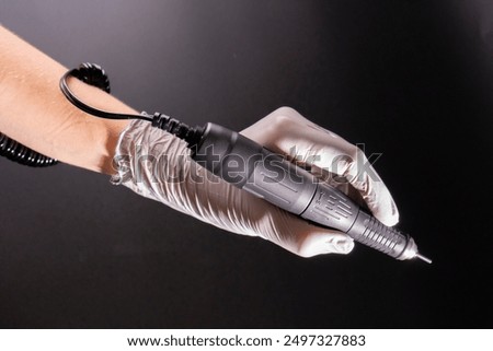 Close up professional manicure master using electric machine.
Manicure electric drill machine. beauty and health concept