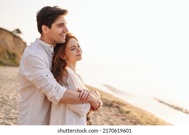 Close up profile happy satisfied smiling young couple two friends family man woman 20s in white clothes hug rest together at sunrise over sea beach ocean outdoor seaside in summer day sunset evening. - Shutterstock ID 2170619601