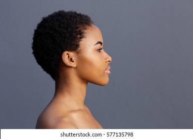 Close up profile portrait of african american young woman against gray background
