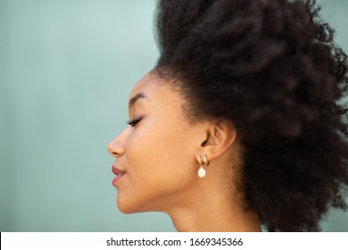 Close Up Profile Portrait Beautiful Young African American Woman With Afro Hair And Eyes Closed By Green Background