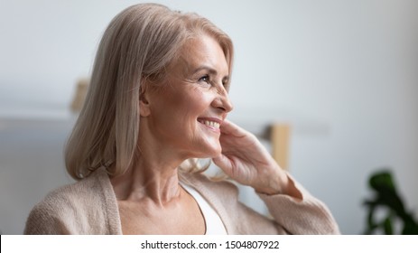 Close Up Profile Portrait Smiling Mature Woman Dreaming, Thinking About Good Future, Beautiful Retired Older Female With Healthy Toothy Smile Looking In Distance, Feeling Satisfied, Natural Beauty