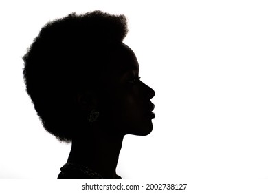 Close up profile silhouette portrait of african american black woman on white studio background. - Shutterstock ID 2002738127
