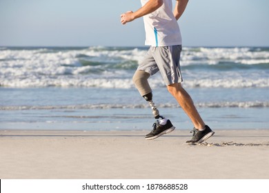 Close Up Of a prosthetic Leg of a man Running Along the Beach - Powered by Shutterstock