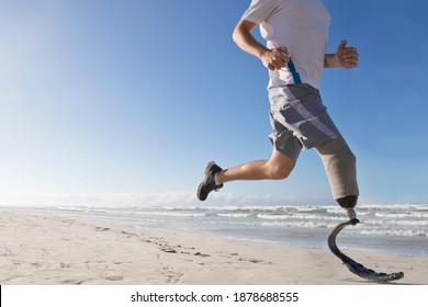 Close up of the prosthetic Leg of a man Running Along the Beach