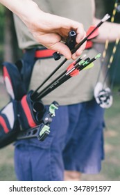 Close up of a pulling an arrow out of his pocket