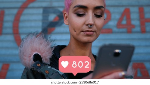 Close up of a punk woman checking her phone with a heart icon increasing numbers below 4k