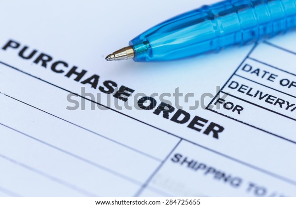 Close up purchase order with blue pen in the\
office, focus on paper