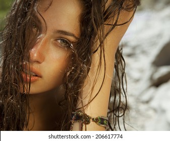 Close Up Of Pure Woman Beauty With Wet Hair And Bright Skin. Toned In Warm Colors. Horizontal Shot On The Beach.