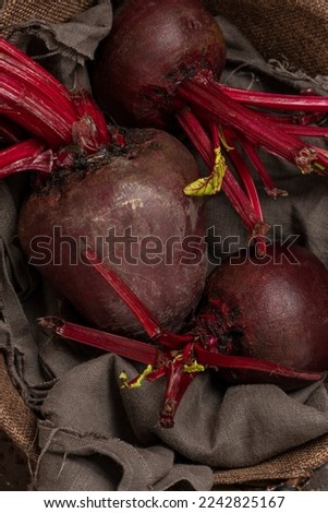 Close up of purple beetroot in the basket at the table
