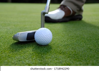 close up of a putt hitting a golf ball - Powered by Shutterstock