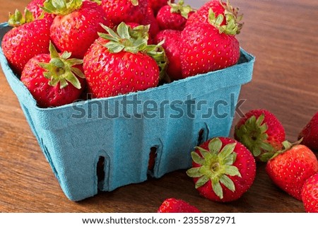 Close up quart of strawberries on a rustic wooden table. Part of the summer fresh fruit crop from the farmer's market ストックフォト © 