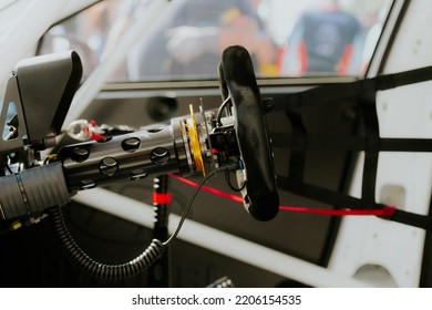 Close Up Of Racing Car Steering Wheel Side View Of Driver Seat And Cockpit