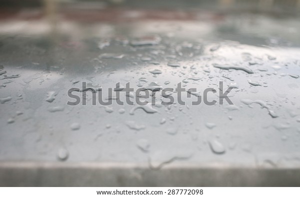 Close up rain drops on roof\
top car