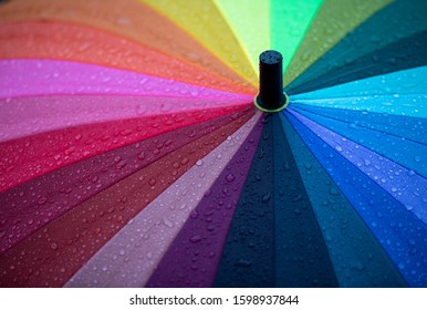 Close Up Of Rainbow Umbrella In Rain