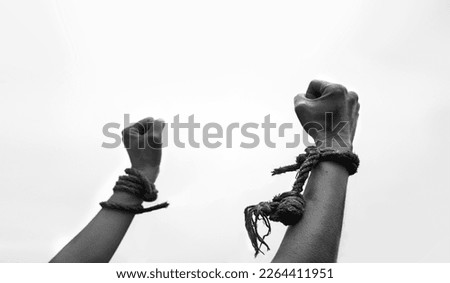Close up raise fist jail abuse right ask god religion faith belief help hope white text space. Closeup pain string cord knot bind wrist young restrain stress addict release convict religious victory