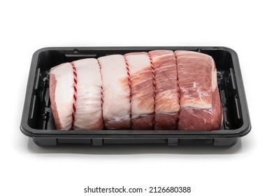Close up a raw cut of pork loin, tied up and rolled with butcher's string in a black plastic container, 45-degree angle view, the isolated image on white background.