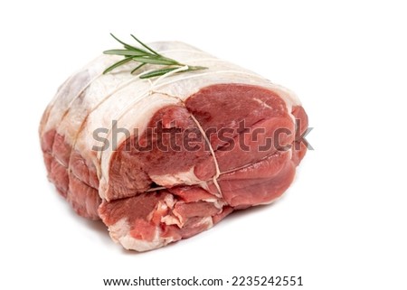 Close up of a raw lamb roast in white background isolated.