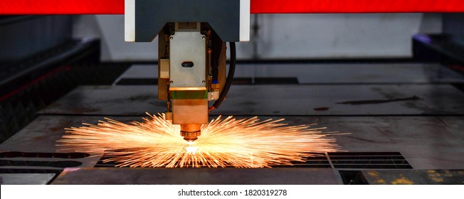 Close up Raytools laser cut head machine while cutting the sheet metal with the sparking light in factory, banner side