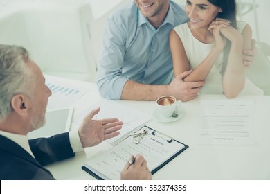 Close Up Of Real Estate Agent Giving Consultation To Family Couple