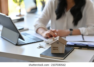 Close up with Real estate agent working with tablet and calculator for analyze business data, real estate, home loan, investment and insurance concept. - Shutterstock ID 2107030562