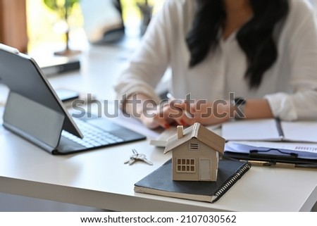 Close up with Real estate agent working with tablet and calculator for analyze business data, real estate, home loan, investment and insurance concept.