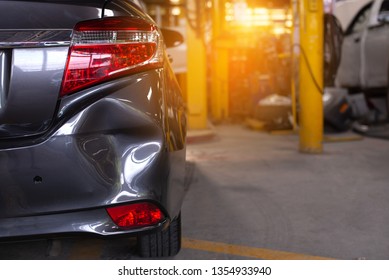 Close up of the rear bumper dent of a grey car in preparation of repair work,Make the surface of the car smooth ,preparing for painting at station service. - Shutterstock ID 1354933940