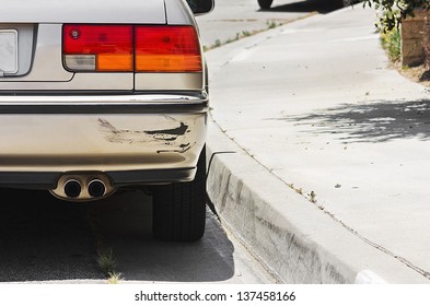 Close Up Of A Rear Car Bumper Side Swiped.