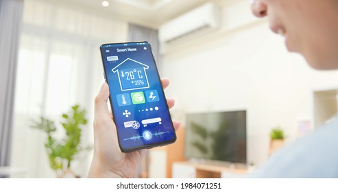 Close Up Rear View Of Asian Young Woman Using Smart Home App With Voice Assistant To Control Air Conditioner Power Saving Mode On Mobile Phone