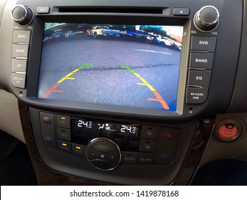 close up rear view of car showing on digital touch screen interface navigation while drive backwards and interior modern dashboard with multimedia system control button, technology for safety driving