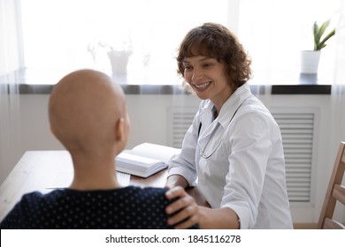 Close Up Rear View Doctor Supporting Hairless Woman At Meeting, Touching Shoulder, Patient Struggling With Cancer, Oncology Disease Visiting Specialist, Oncologist, Healthcare And Treatment Concept