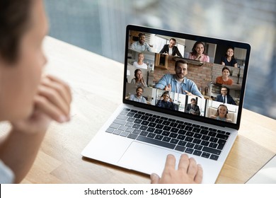 Close up rear view of person talk speak on video call with multiracial diverse colleagues. Employee have webcam team online meeting or group digital briefing on computer with multiethnic coworkers. - Shutterstock ID 1840196869