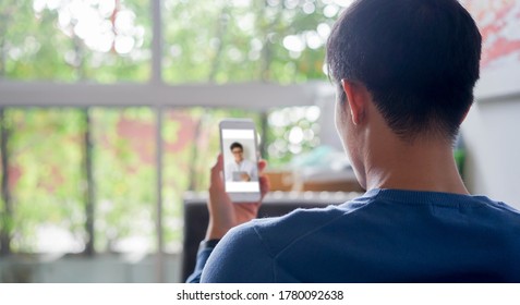 close up rear view of young man video streaming conference to  consulting about male hormone and physical with specialist and listen explaining at home for telemedicine health technology life concept
