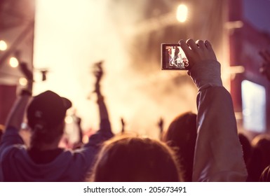 Close Up Of Recording Video With Smartphone During A Concert. Toned Picture