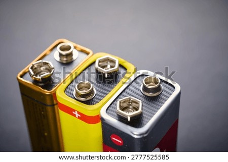 Close up of a rectangular nine volt batteries on a black table.