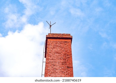 Close Up Of Red Brick Chimney With Blue Sky Background