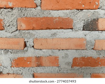 
Close Up Red Brick Wall Texture with Cement Mortar Background

A detailed close-up of a red brick wall with rough cement mortar, showing natural texture, cracks, and uneven surface. Ideal for construction, architecture, industrial background, or design elements with copy space.