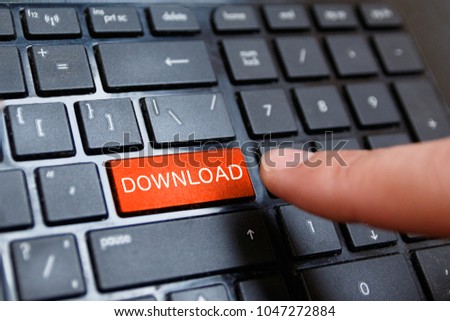 Close up of red button with text of DOWNLOAD on the black computer keyboard