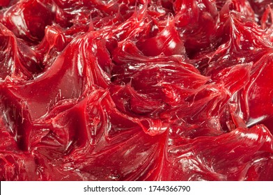 Close Up Of Red Colored Industrial Grease.
Rich And Thick Texture Of Industrial Grade Grease Used To Smooth Out All Metal Friction