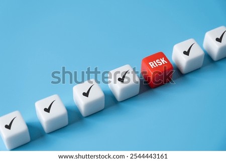 close up at the red cube to identify red danger risk cube among other normal incident. Risk management concept for business and personal planning for risk mitigation.