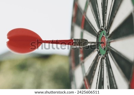 close up red dart arrow hitting on target center of dartboard, sport and recreation, planning and manage to success business concept