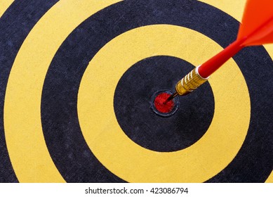 Close up red dart target with arrow hitting on bullseye of dartboard