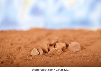 Close Up Red Desert Sand With Wold Map Background. 