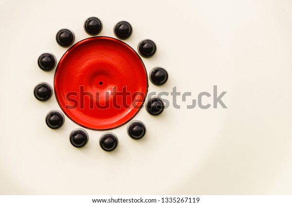 Close up of red detailed black bolts\
screws on car truck wheel. Abstract background\
concept.