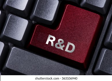 close up red enter button written R&D