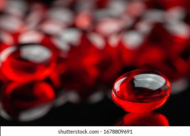 Close Up Of Red Gel Capsule On Black Background