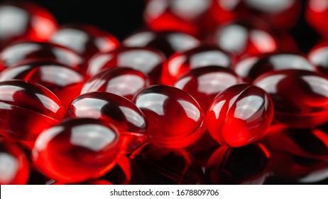 Close Up Of Red Gel Capsule On Black Background