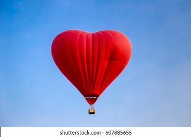 Close Up Of Red Heart Shape Hot Air Balloon In Blue Sky