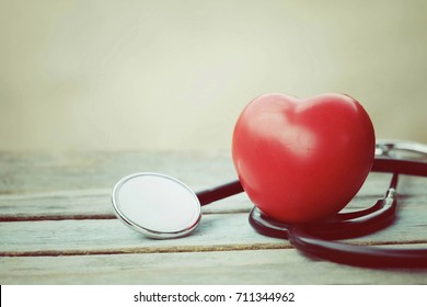 Close Up Red Heart And Stethoscope On Old Wood Table With Copy Space Background, World Health Day And Healthcare Concept, Process Vintage Tone