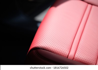 Close Up Of Red Interior In Luxury Car. Perforated Leather Seat Of Modern Sports Car. Car Upholstery Concept.  Interior Car Detail & Leather Seat Restoration Background.